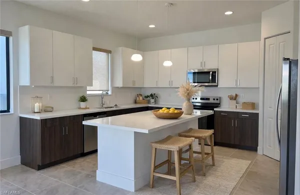 a kitchen with stainless steel appliances granite countertop a stove a sink and a refrigerator