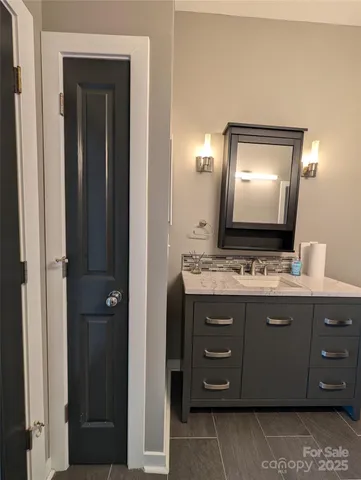 a bathroom with a double vanity sink and a mirror