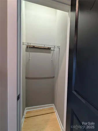 a view of walk in closet with empty racks