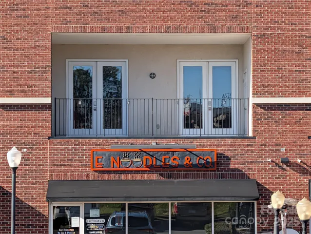 a view of a house with a big yard and sitting area