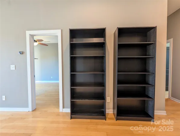 a view of walk in closet with empty racks
