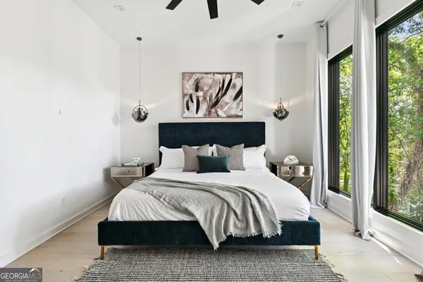 a bedroom with a bed and large window