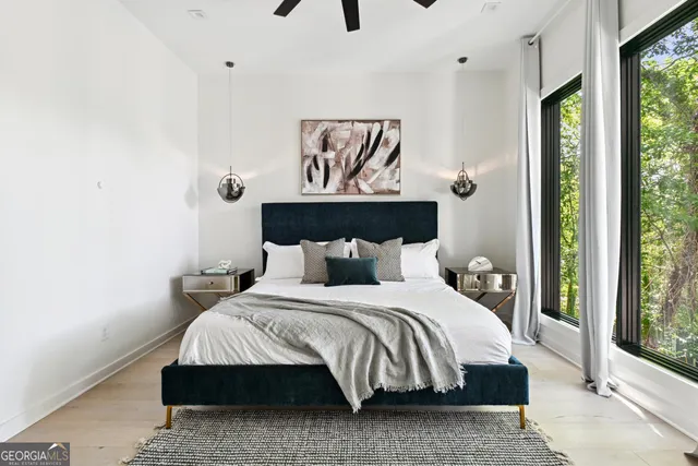 a bedroom with a bed and large window