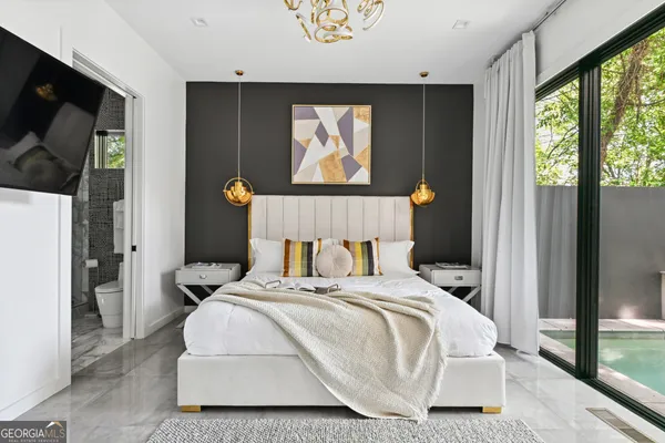 a bedroom with a bed and glass wall