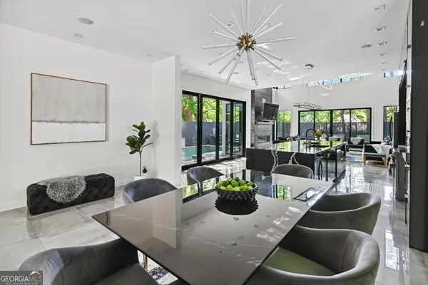 a living room with furniture potted plant and a large window