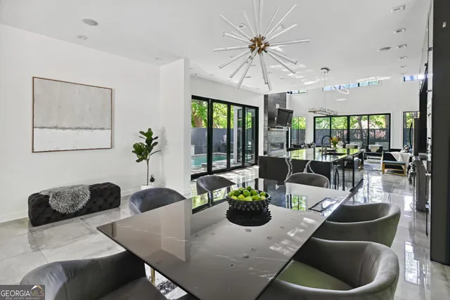 a living room with furniture potted plant and a large window