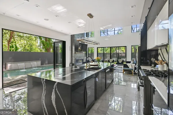 a kitchen with counter top space and living room
