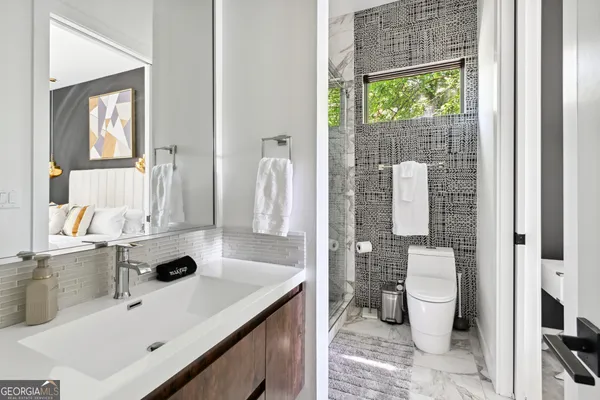 a bathroom with a sink toilet and a mirror