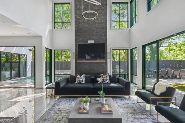 a living room with furniture and a floor to ceiling window