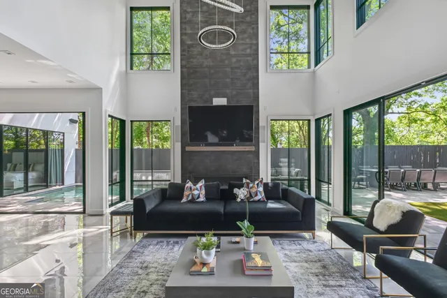 a living room with furniture and a floor to ceiling window