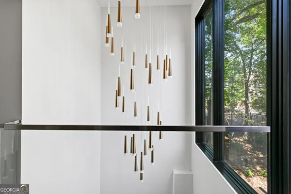 a view of staircase with railing and white walls