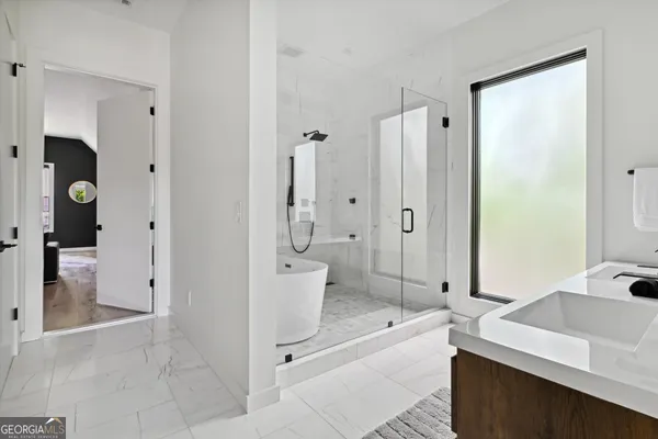 a spacious bathroom with a double vanity sink toilet and shower