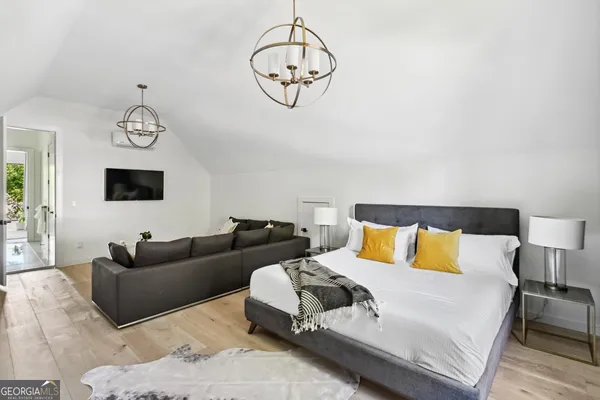 a living room with furniture a large bed and a chandelier