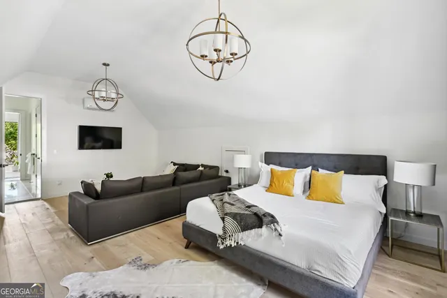 a living room with furniture a large bed and a chandelier