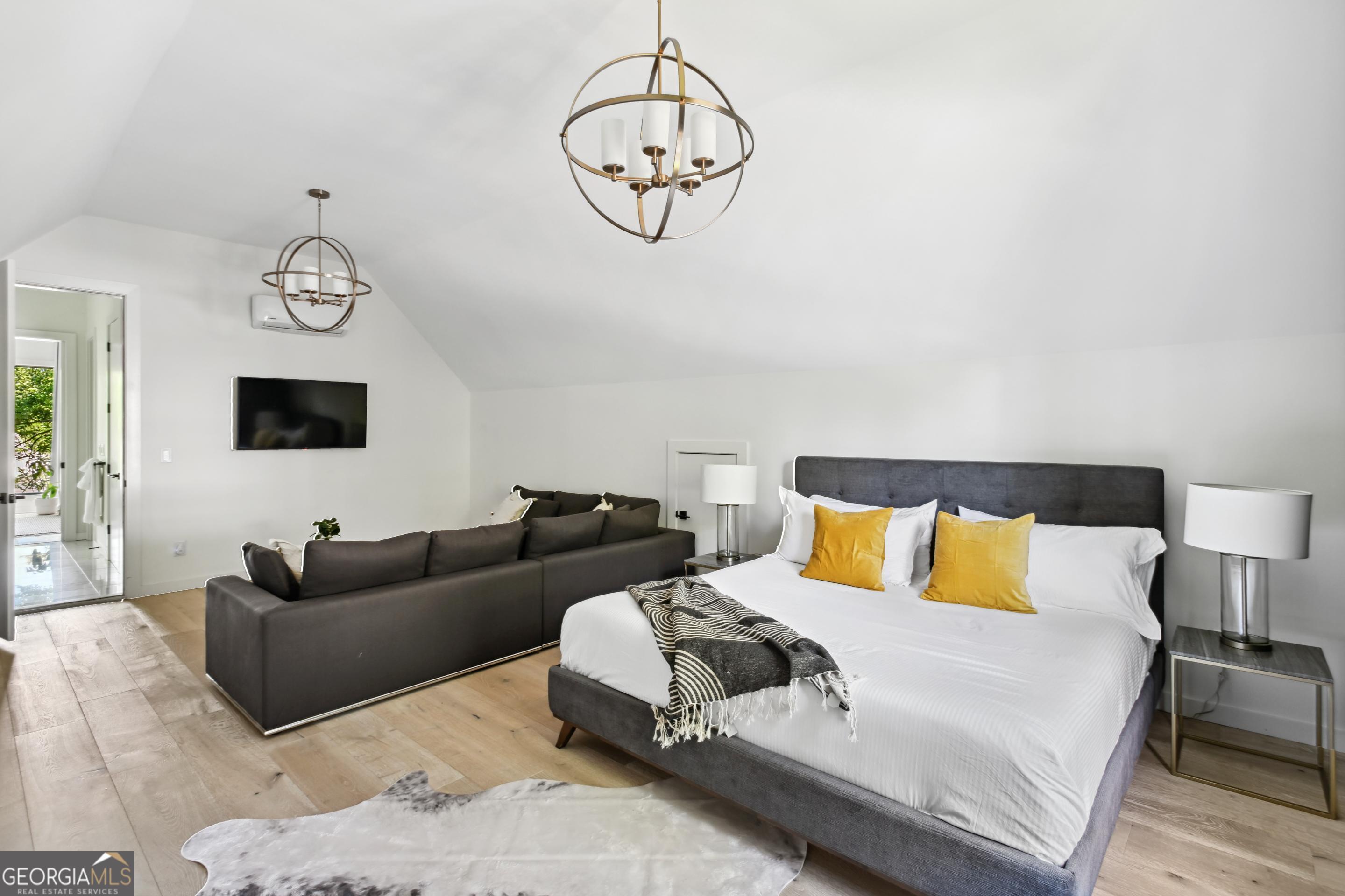 818 Verner Street Northwest Atlanta, GA 30318 - Photo 37 of 47 a living room with furniture a large bed and a chandelier