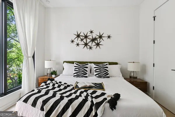 a bedroom with a bed and a window