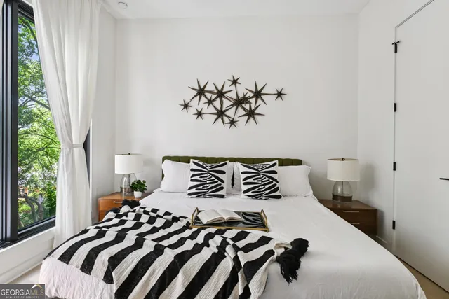 a bedroom with a bed and a window