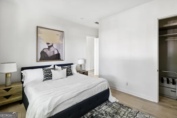 a bedroom with a bed and a night stand