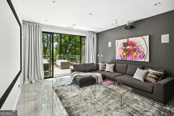 a living room with furniture a rug and a large window