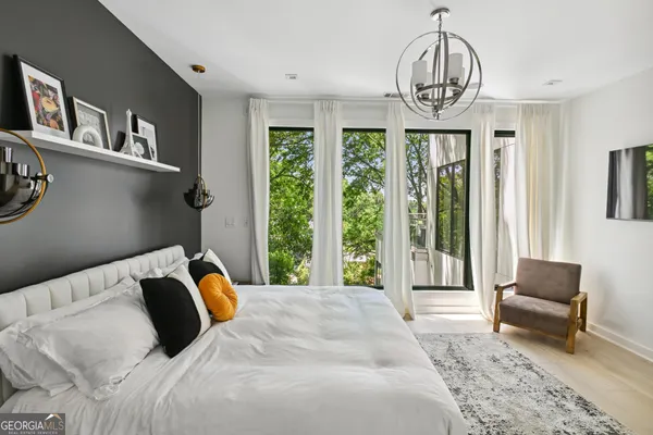 a bedroom with a bed and a chandelier