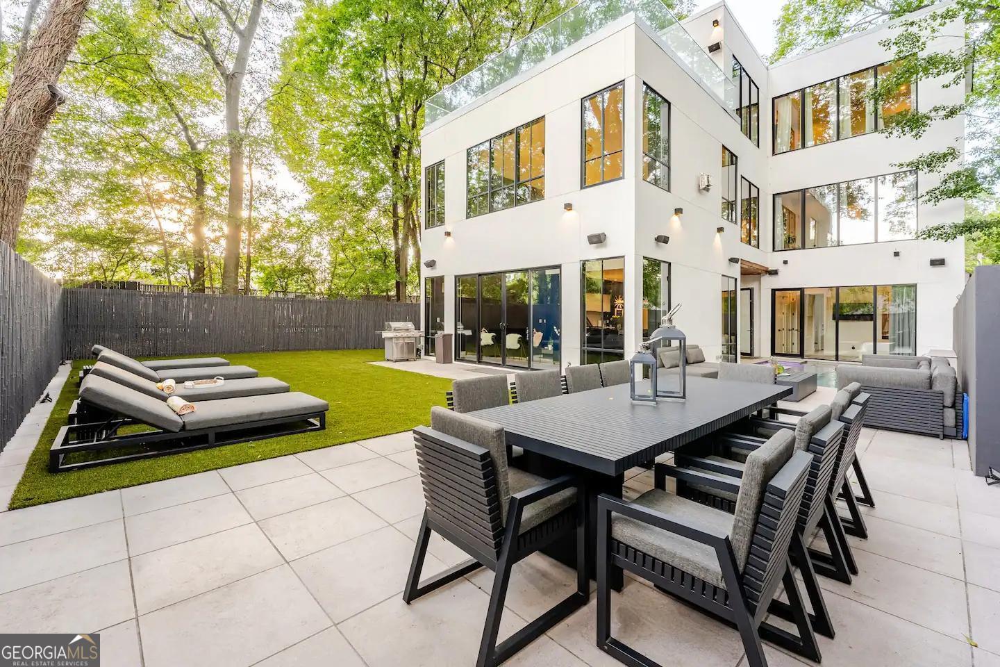 818 Verner Street Northwest Atlanta, GA 30318 - Photo 5 of 47 a view of a patio with table and chairs and potted plants with wooden fence