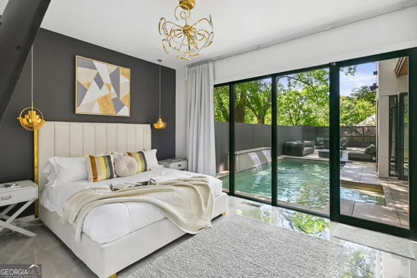 a bedroom with a bed and a painting on the wall