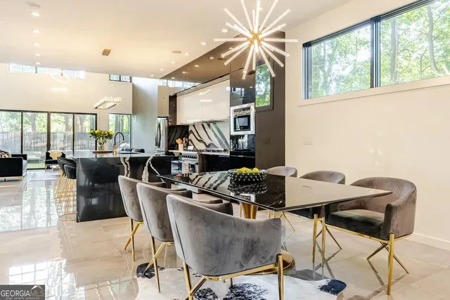 a dining room with furniture a chandelier and wooden floor