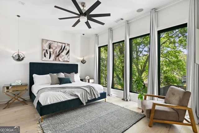 a spacious bedroom with a bed couch and a large window