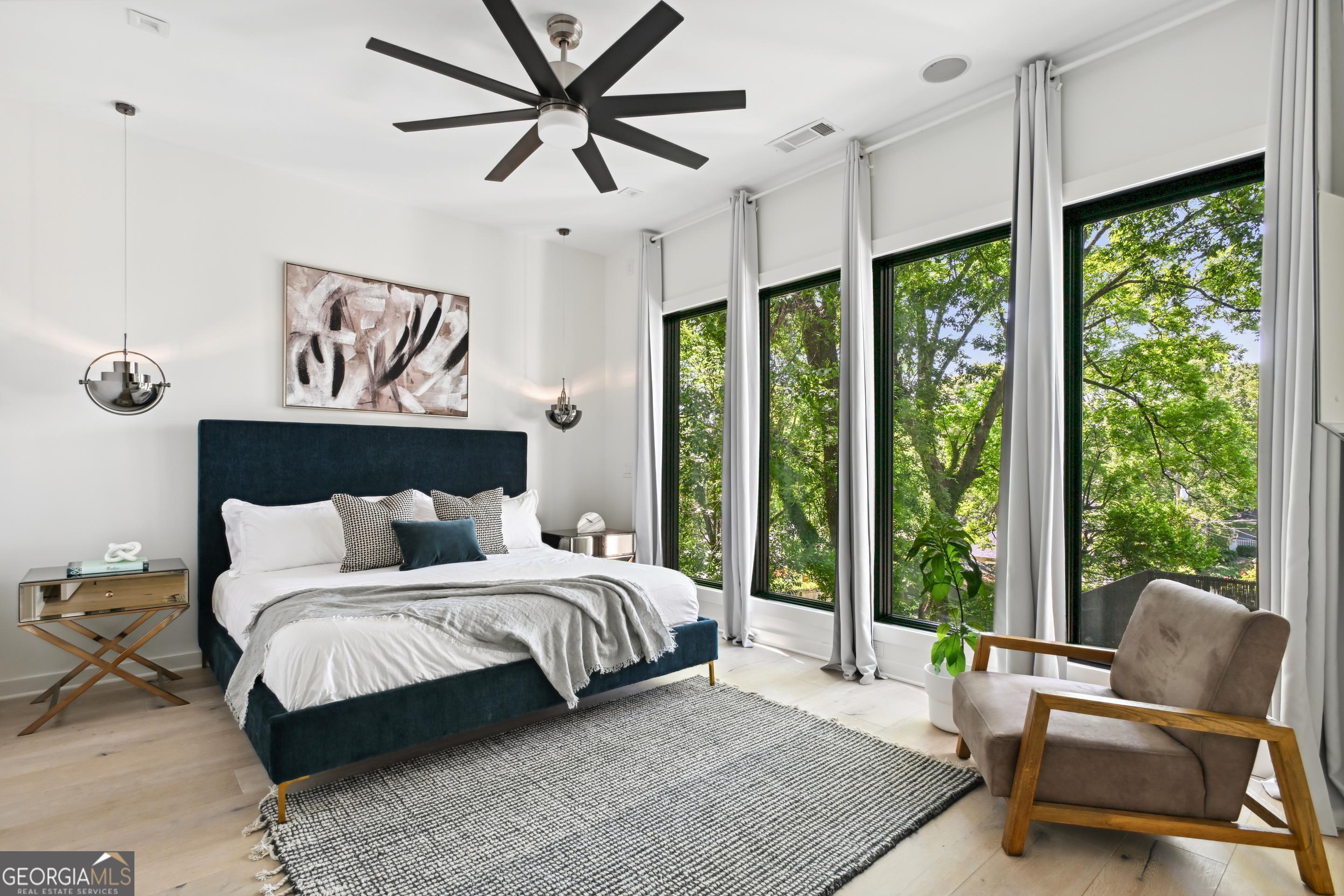 818 Verner Street Northwest Atlanta, GA 30318 - Photo 10 of 47 a spacious bedroom with a bed couch and a large window