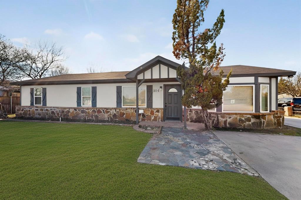 104 Maxwell Road Hackberry, TX 75036 - Photo 1 of 32 a front view of a house with a garden and trees