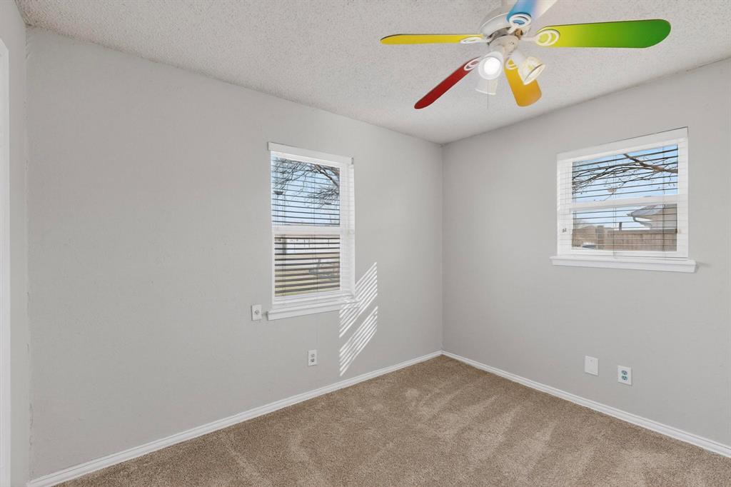 104 Maxwell Road Hackberry, TX 75036 - Photo 13 of 32 an empty room with window and ceiling fan