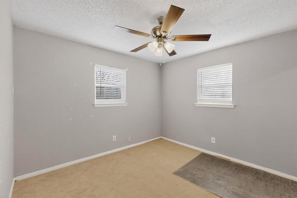 104 Maxwell Road Hackberry, TX 75036 - Photo 16 of 32 an empty room with a window and a ceiling fan
