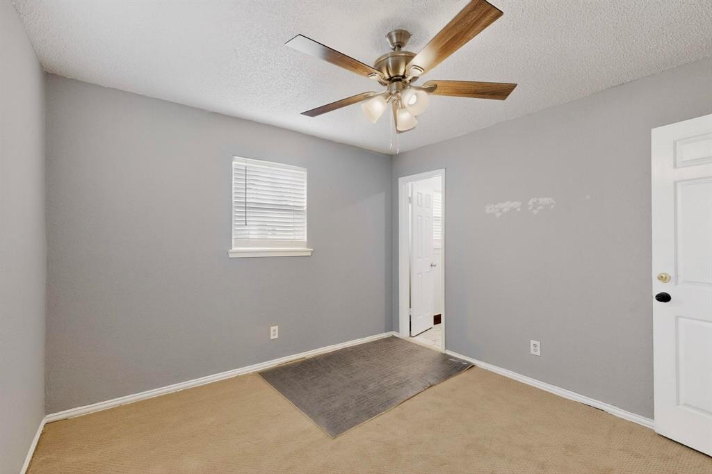 104 Maxwell Road Hackberry, TX 75036 - Photo 17 of 32 an empty room with a window and a fan