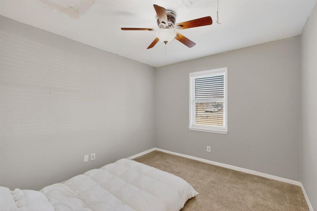 104 Maxwell Road Hackberry, TX 75036 - Photo 22 of 32 a view of a big room with carpet and windows