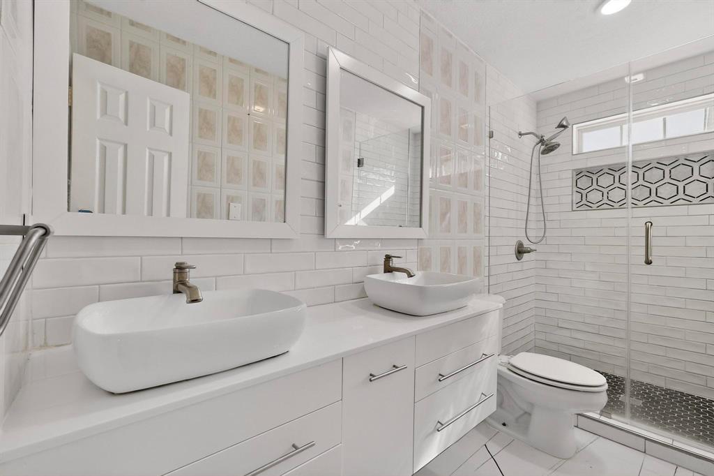 104 Maxwell Road Hackberry, TX 75036 - Photo 30 of 32 a bathroom with a sink toilet and mirror