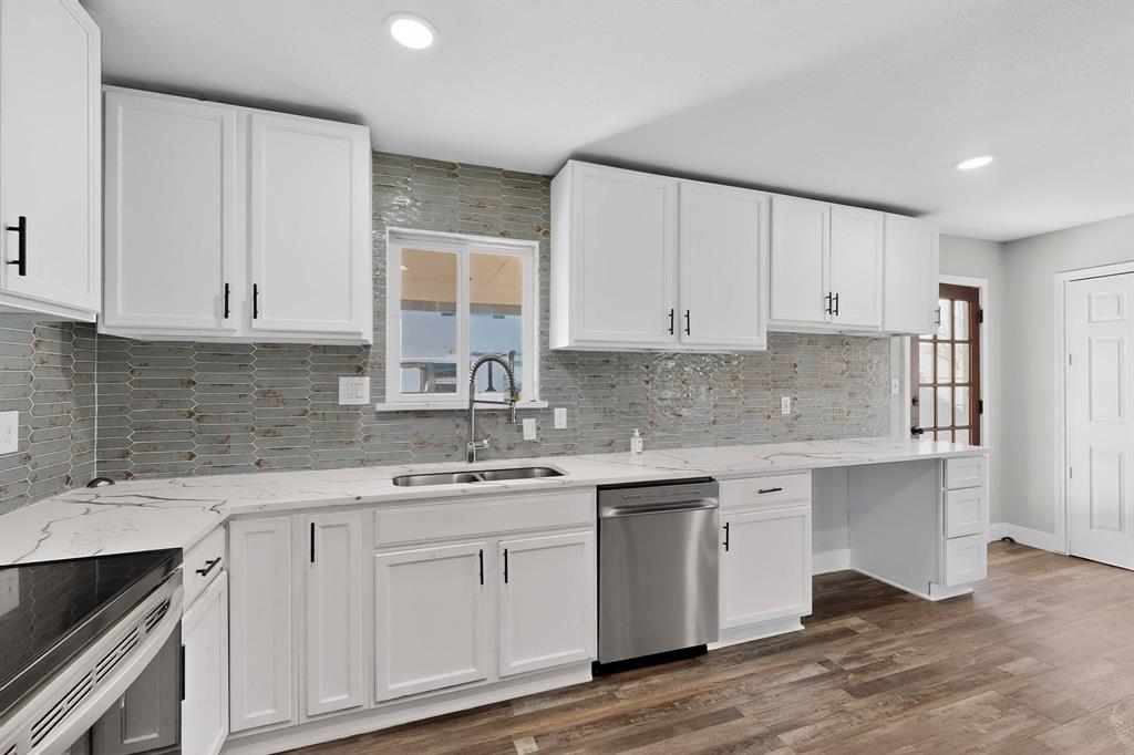 104 Maxwell Road Hackberry, TX 75036 - Photo 9 of 32 a kitchen with stainless steel appliances granite countertop a sink stove and cabinets