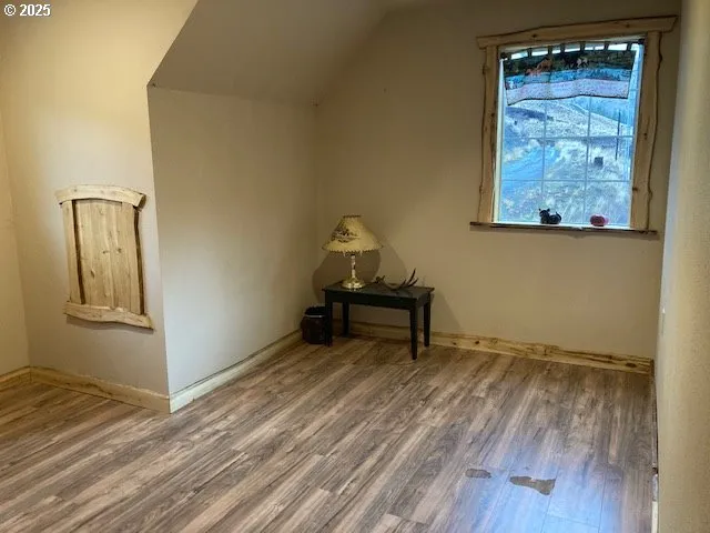 a room with a bench and wooden floor