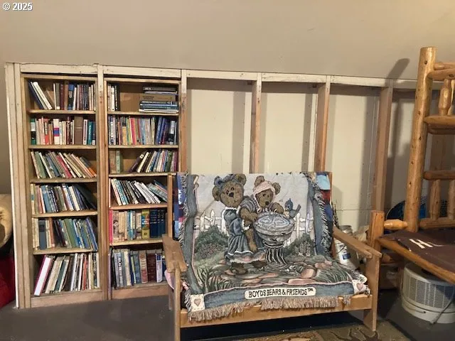 a view of living room with furniture and book shelf