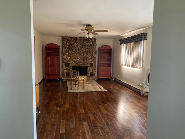81 North 17th Road Lostant, IL 61334 - Photo 6 of 16 an empty room with wooden floor fireplace and windows