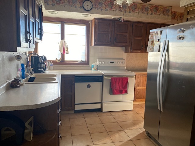 81 North 17th Road Lostant, IL 61334 - Photo 8 of 16 a kitchen with kitchen island granite countertop a sink stove and refrigerator