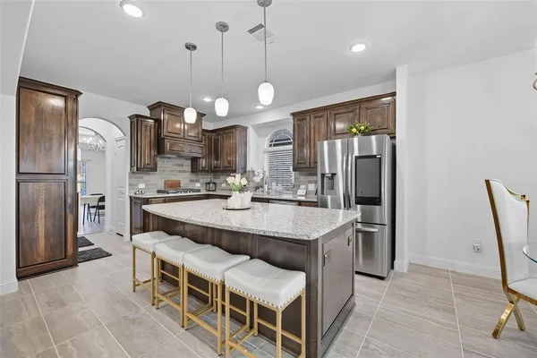 a large kitchen with a table and chairs