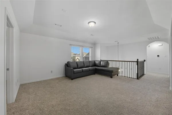 a living room with furniture and a ceiling fan