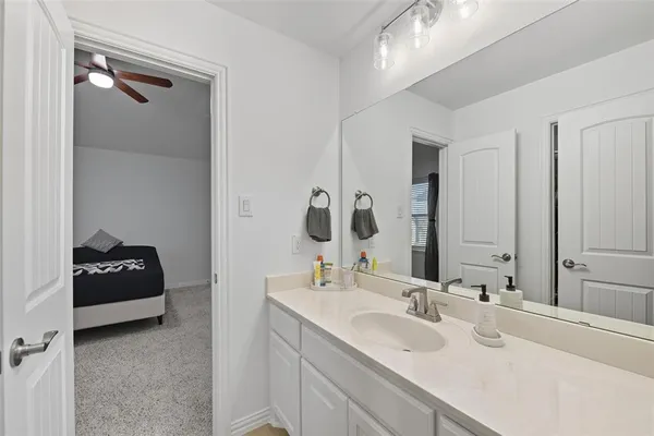 a bathroom with a double vanity sink and mirror