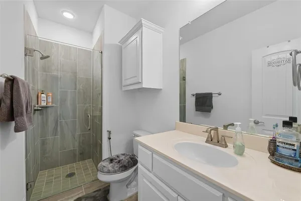 a bathroom with a sink toilet and shower