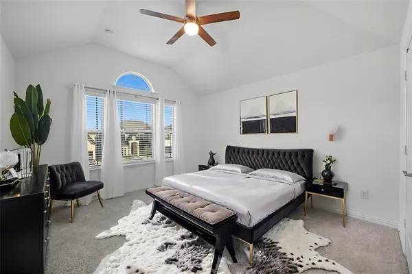 a bedroom with furniture and a window