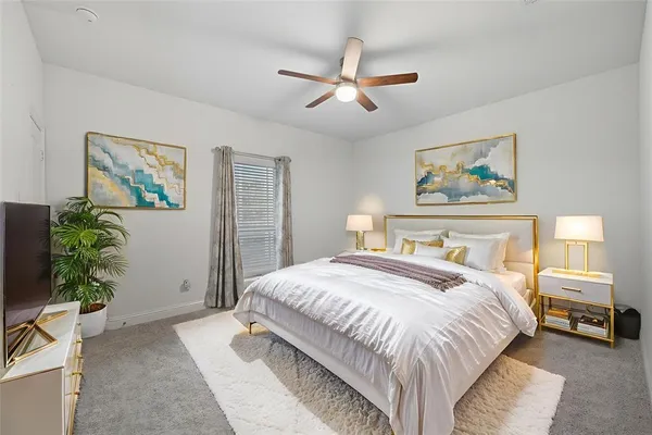 a bedroom with a large bed and a chandelier