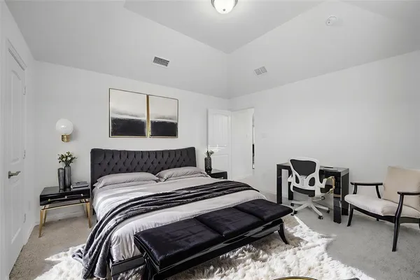 a bedroom with a bed and a chair