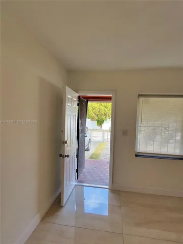 an entryway with a livingroom view and a bathtub