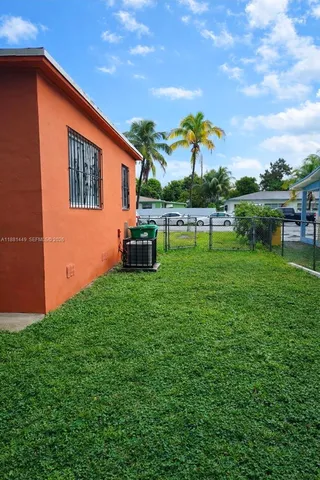 a backyard of a house with table and chairs