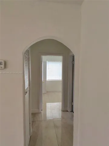 a hallway with sliding door and yard in back